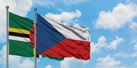 Dominica and Czech Republic flag waving in the wind against white cloudy blue sky together. Diplomacy concept, international relations.