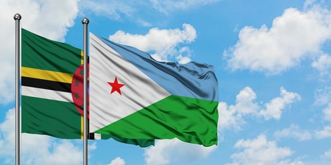 Dominica and Djibouti flag waving in the wind against white cloudy blue sky together. Diplomacy concept, international relations.