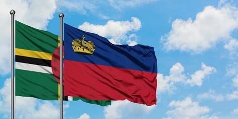 Dominica and Liechtenstein flag waving in the wind against white cloudy blue sky together. Diplomacy concept, international relations.