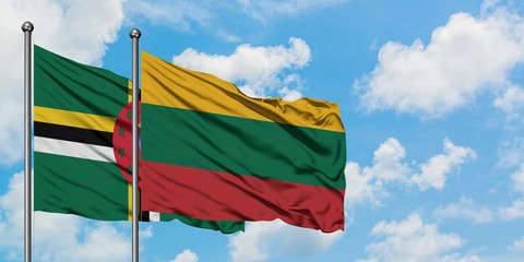 Dominica and Lithuania flag waving in the wind against white cloudy blue sky together. Diplomacy concept, international relations.
