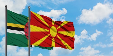 Dominica and Macedonia flag waving in the wind against white cloudy blue sky together. Diplomacy concept, international relations.