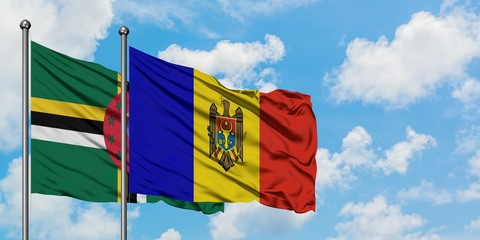 Dominica and Moldova flag waving in the wind against white cloudy blue sky together. Diplomacy concept, international relations.