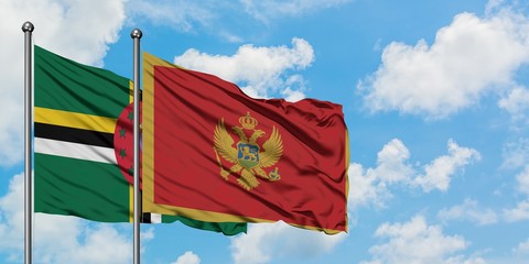 Dominica and Montenegro flag waving in the wind against white cloudy blue sky together. Diplomacy concept, international relations.