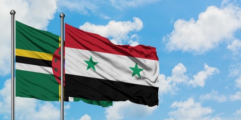 Dominica and Syria flag waving in the wind against white cloudy blue sky together. Diplomacy...