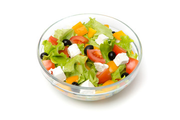 Greek salad in a glass bowl Isolated on white background