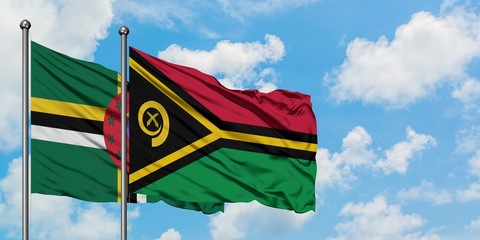 Dominica and Vanuatu flag waving in the wind against white cloudy blue sky together. Diplomacy concept, international relations.