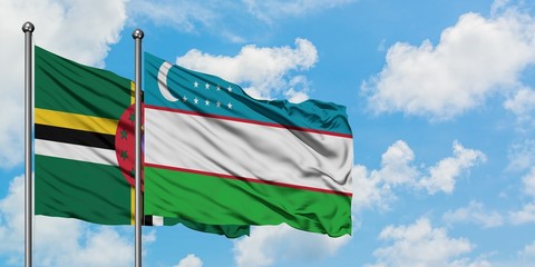 Dominica and Uzbekistan flag waving in the wind against white cloudy blue sky together. Diplomacy concept, international relations.