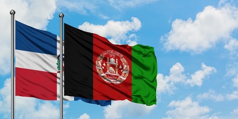 Dominican Republic and Afghanistan flag waving in the wind against white cloudy blue sky together. Diplomacy concept, international relations.