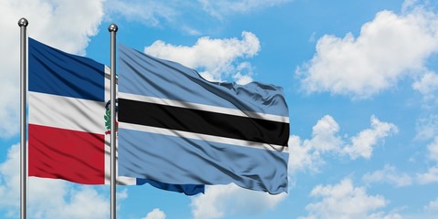 Dominican Republic and Botswana flag waving in the wind against white cloudy blue sky together. Diplomacy concept, international relations.