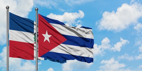 Dominican Republic and Cuba flag waving in the wind against white cloudy blue sky together. Diplomacy concept, international relations.