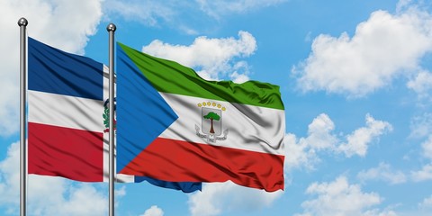 Dominican Republic and Equatorial Guinea flag waving in the wind against white cloudy blue sky together. Diplomacy concept, international relations.