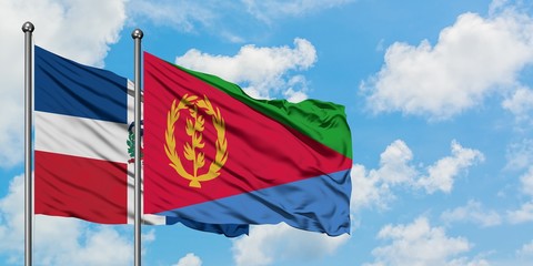 Dominican Republic and Eritrea flag waving in the wind against white cloudy blue sky together. Diplomacy concept, international relations.