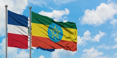 Dominican Republic and Ethiopia flag waving in the wind against white cloudy blue sky together. Diplomacy concept, international relations.