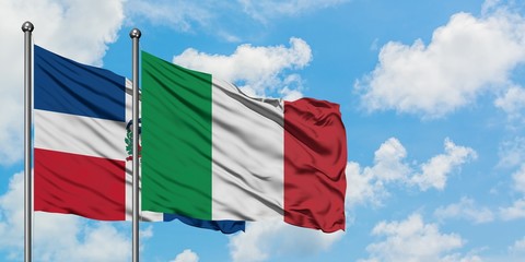 Dominican Republic and Italy flag waving in the wind against white cloudy blue sky together. Diplomacy concept, international relations.