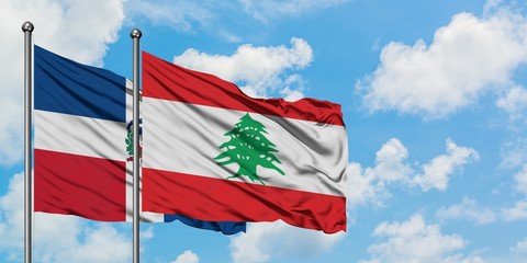Dominican Republic and Lebanon flag waving in the wind against white cloudy blue sky together. Diplomacy concept, international relations.