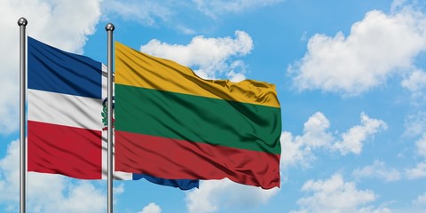 Dominican Republic and Lithuania flag waving in the wind against white cloudy blue sky together. Diplomacy concept, international relations.