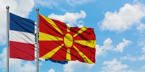 Dominican Republic and Macedonia flag waving in the wind against white cloudy blue sky together. Diplomacy concept, international relations.