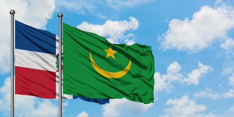 Dominican Republic and Mauritania flag waving in the wind against white cloudy blue sky together. Diplomacy concept, international relations.