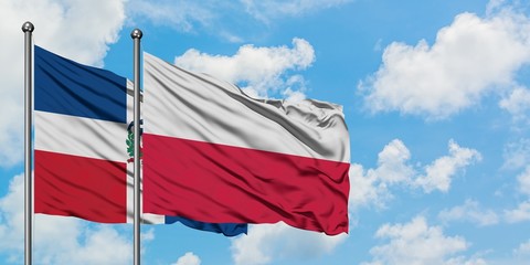 Dominican Republic and Poland flag waving in the wind against white cloudy blue sky together. Diplomacy concept, international relations.