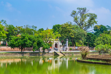 Fototapeta na wymiar Scenery of Thuong shrine with lake and traditional well in ancient Co Loa citadel, Vietnam. Co Loa was capital of Au Lac (old Vietnam), the country was founded by Thuc Phan about 2nd century BC.