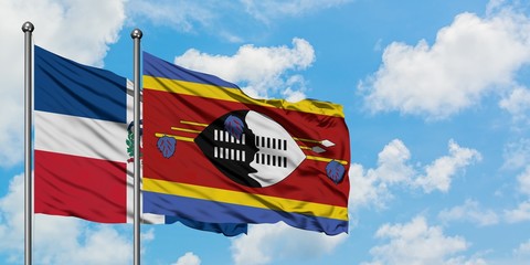 Dominican Republic and Swaziland flag waving in the wind against white cloudy blue sky together. Diplomacy concept, international relations.
