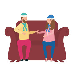 young lovers couple with christmas hat seated in sofa