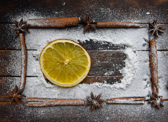 Christmas still life of dried oranges, cinnamon, star anise powdered sugar