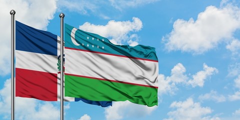 Dominican Republic and Uzbekistan flag waving in the wind against white cloudy blue sky together. Diplomacy concept, international relations.
