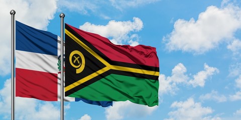Dominican Republic and Vanuatu flag waving in the wind against white cloudy blue sky together. Diplomacy concept, international relations.