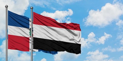 Dominican Republic and Yemen flag waving in the wind against white cloudy blue sky together. Diplomacy concept, international relations.