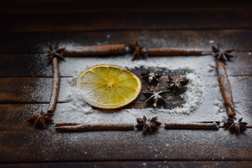 Christmas still life of dried oranges, cinnamon, star anise powdered sugar