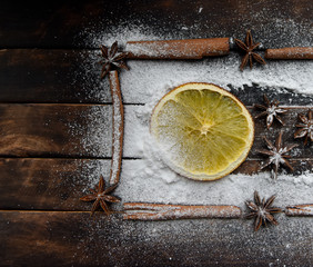 Christmas still life of dried oranges, cinnamon, star anise powdered sugar