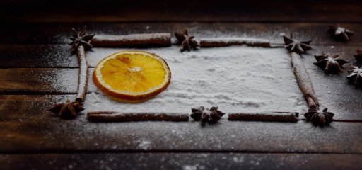 Christmas still life of dried oranges, cinnamon, star anise powdered sugar