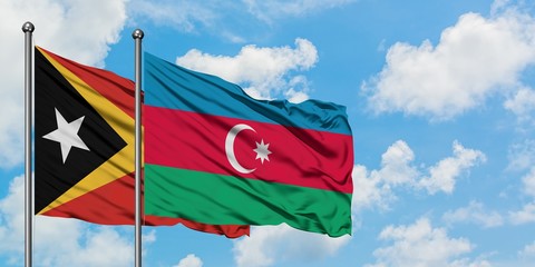 East Timor and Azerbaijan flag waving in the wind against white cloudy blue sky together. Diplomacy concept, international relations.