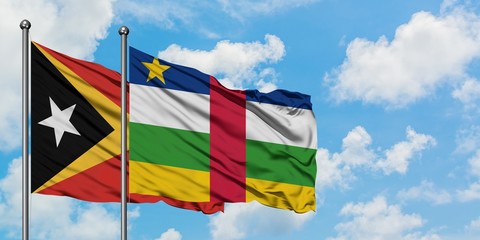 East Timor and Central African Republic flag waving in the wind against white cloudy blue sky together. Diplomacy concept, international relations.