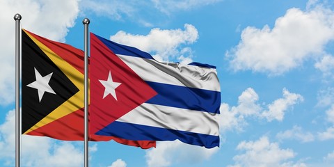 East Timor and Cuba flag waving in the wind against white cloudy blue sky together. Diplomacy concept, international relations.