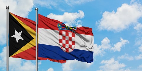 East Timor and Croatia flag waving in the wind against white cloudy blue sky together. Diplomacy concept, international relations.