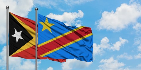 East Timor and Congo flag waving in the wind against white cloudy blue sky together. Diplomacy concept, international relations.