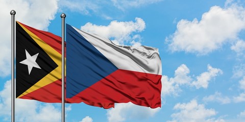 East Timor and Czech Republic flag waving in the wind against white cloudy blue sky together. Diplomacy concept, international relations.