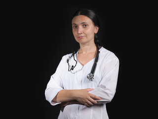 Female doctor shows hand gestures and poses on a black background.  Female doctor in white coat shows different emotions posing on black background. Doctor template.