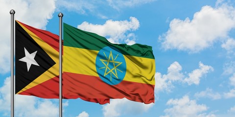 East Timor and Ethiopia flag waving in the wind against white cloudy blue sky together. Diplomacy concept, international relations.