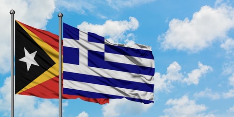 East Timor and Greece flag waving in the wind against white cloudy blue sky together. Diplomacy concept, international relations.