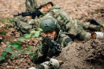 Soldiers in a combat situation. Men play airsoft.