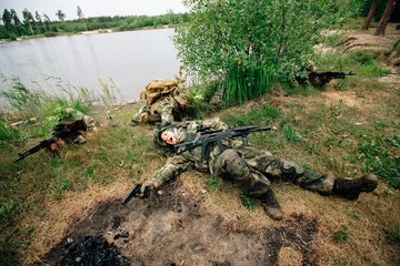 Soldiers in a combat situation. Men play airsoft.