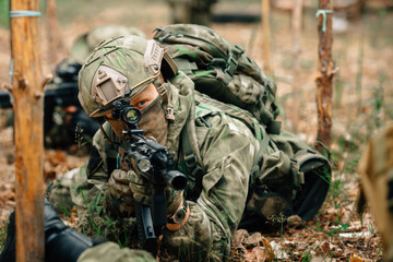 Soldiers in a combat situation. Men play airsoft.