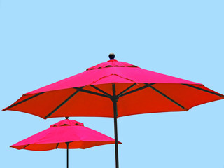 Fototapeta na wymiar Red market umbrella isolated on blue sky