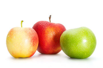 Delicious appetizing beautiful fresh green and two red apples isolated on a white background.