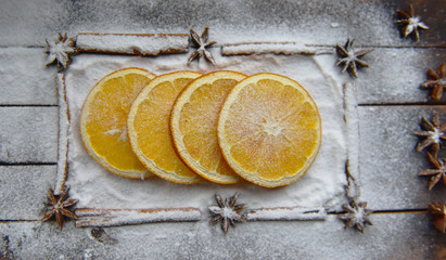 Christmas still life of dried oranges, cinnamon, star anise powdered sugar