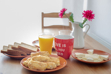 Breakfast with coffee, orange juice, cheese, bread, cheese pie.