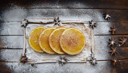 Christmas still life of dried oranges, cinnamon, star anise powdered sugar